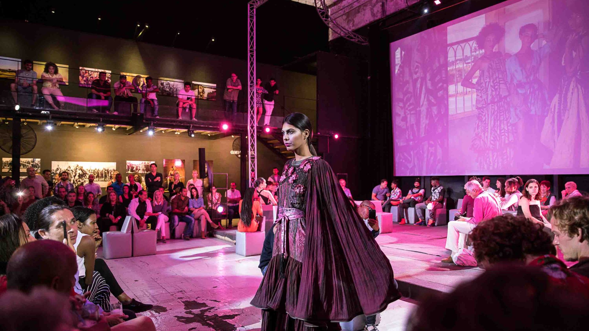 A fashion show in front of an audience.